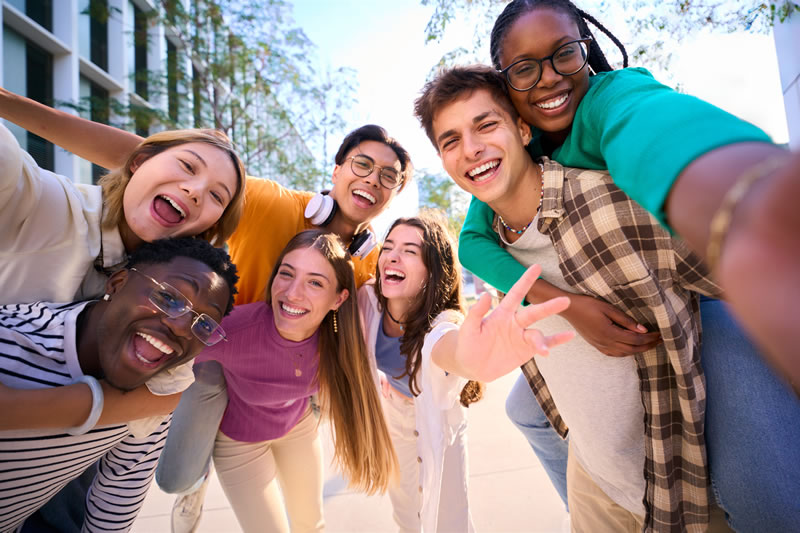 Group of young friends laughing together outdoors