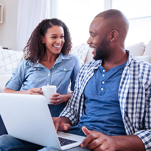 Happy couple reviewing their finances